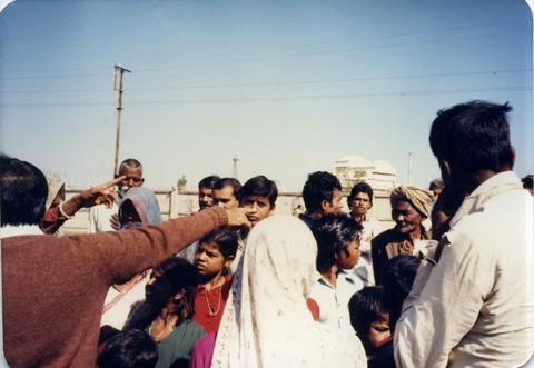 Bhopal 1985 people pointing at the smoke stacks of Union Carbide plant